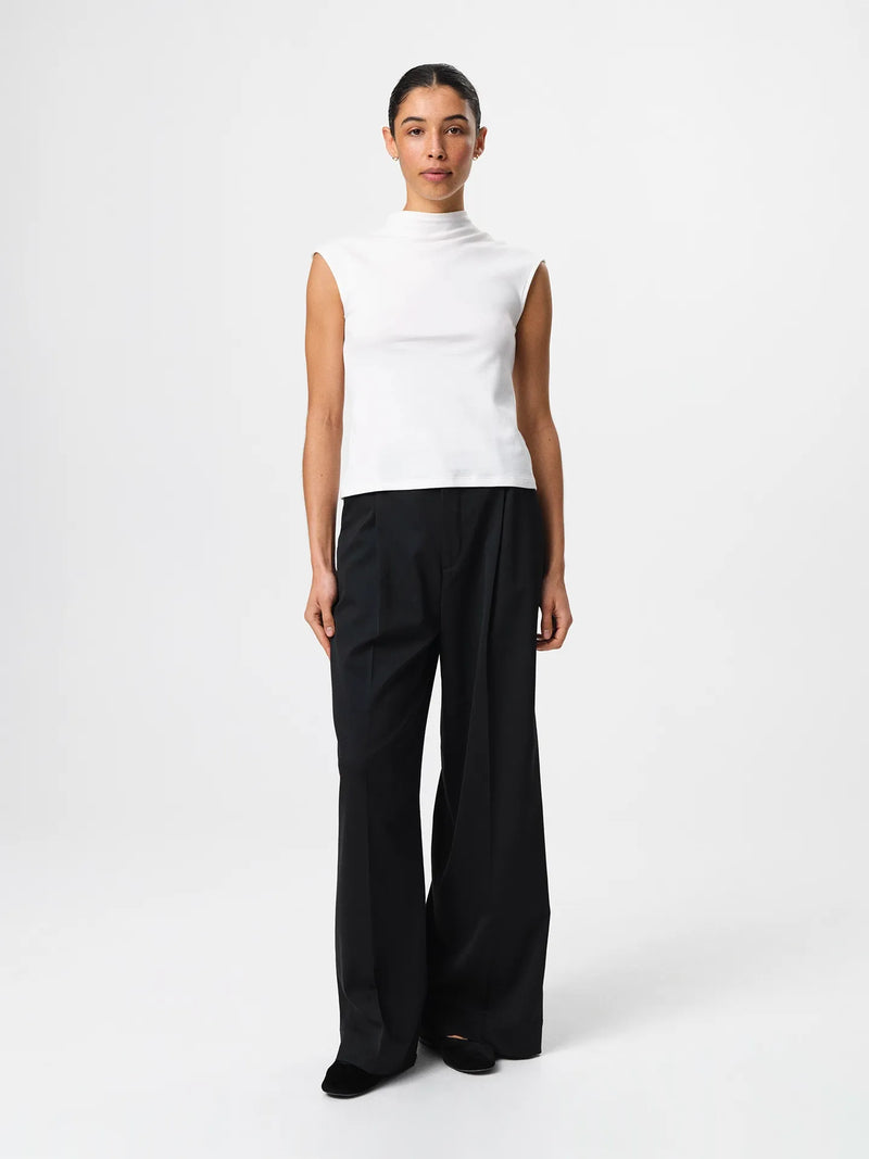 Julie Josephine Ariel Top White: fitted white top made from a 94% Italian pima cotton and 6% polyamide blend, crafted in a smooth stretchy jersey for a soft supportive feel, designed as a versatile wardrobe essential to wear on its own or as an easy layering base under shirts, blazers, and knitwear.