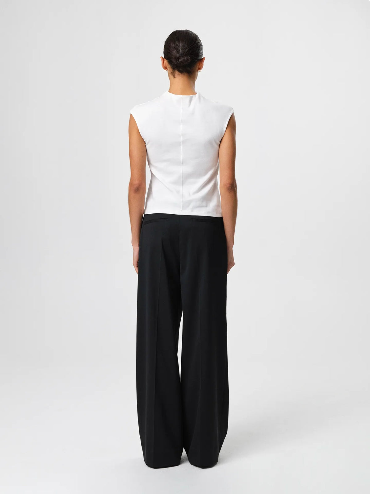 Julie Josephine Ariel Top White: fitted white top made from a 94% Italian pima cotton and 6% polyamide blend, crafted in a smooth stretchy jersey for a soft supportive feel, designed as a versatile wardrobe essential to wear on its own or as an easy layering base under shirts, blazers, and knitwear.