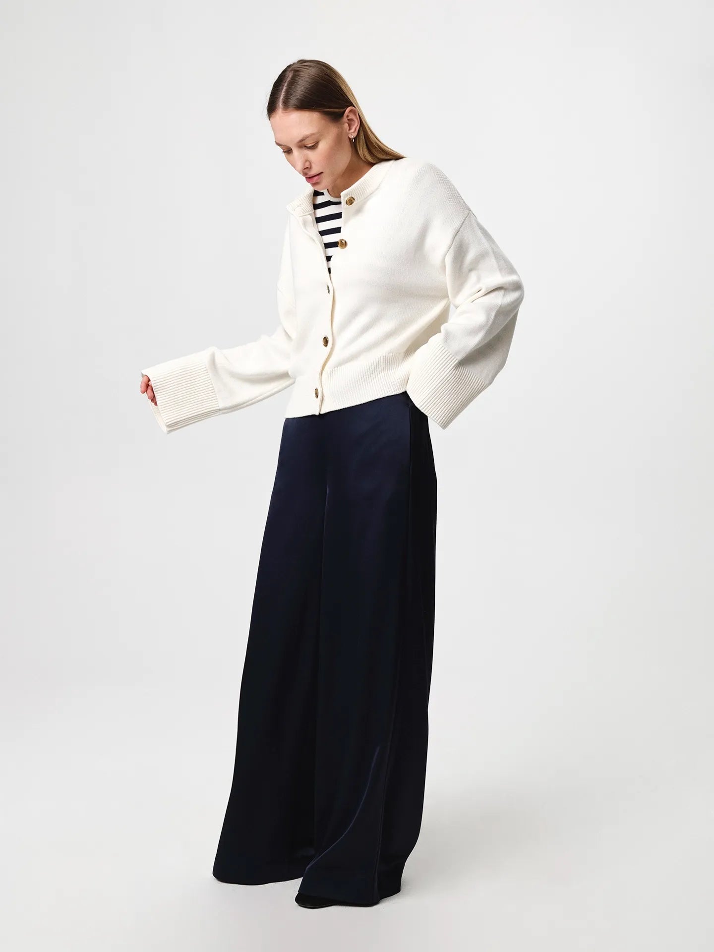 Julie Josephine Henrikke Cardigan: timeless knit cardigan in a 50% wool and 50% cotton blend, designed with a relaxed silhouette and wide loose sleeves, a more fitted waist, ribbed neckline, classic front button fastening, extended loose ribbed cuffs, and a ribbed hem for an understated everyday layering piece.