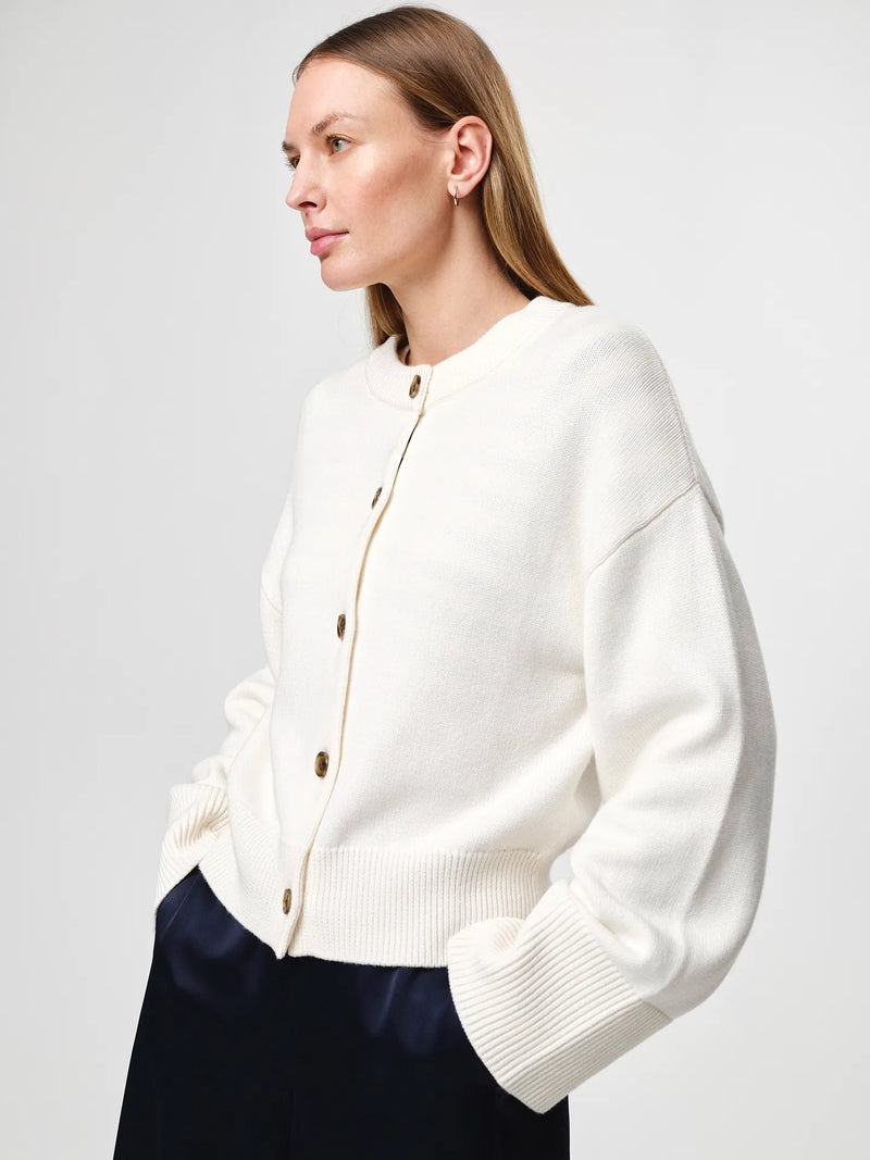 Julie Josephine Henrikke Cardigan: timeless knit cardigan in a 50% wool and 50% cotton blend, designed with a relaxed silhouette and wide loose sleeves, a more fitted waist, ribbed neckline, classic front button fastening, extended loose ribbed cuffs, and a ribbed hem for an understated everyday layering piece.