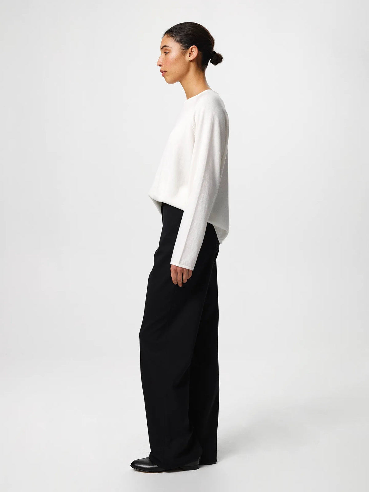 Julie Josephine Kate Roundneck Sweater Off White: product image of a soft, lightweight knit sweater in an off white shade, made from a wool and cotton blend that combines warmth with breathability, designed with a relaxed silhouette, long sleeves, subtle dropped shoulders, and a clean neckline, styled for easy everyday layering over a T shirt or worn on its own with tailored trousers or denim.