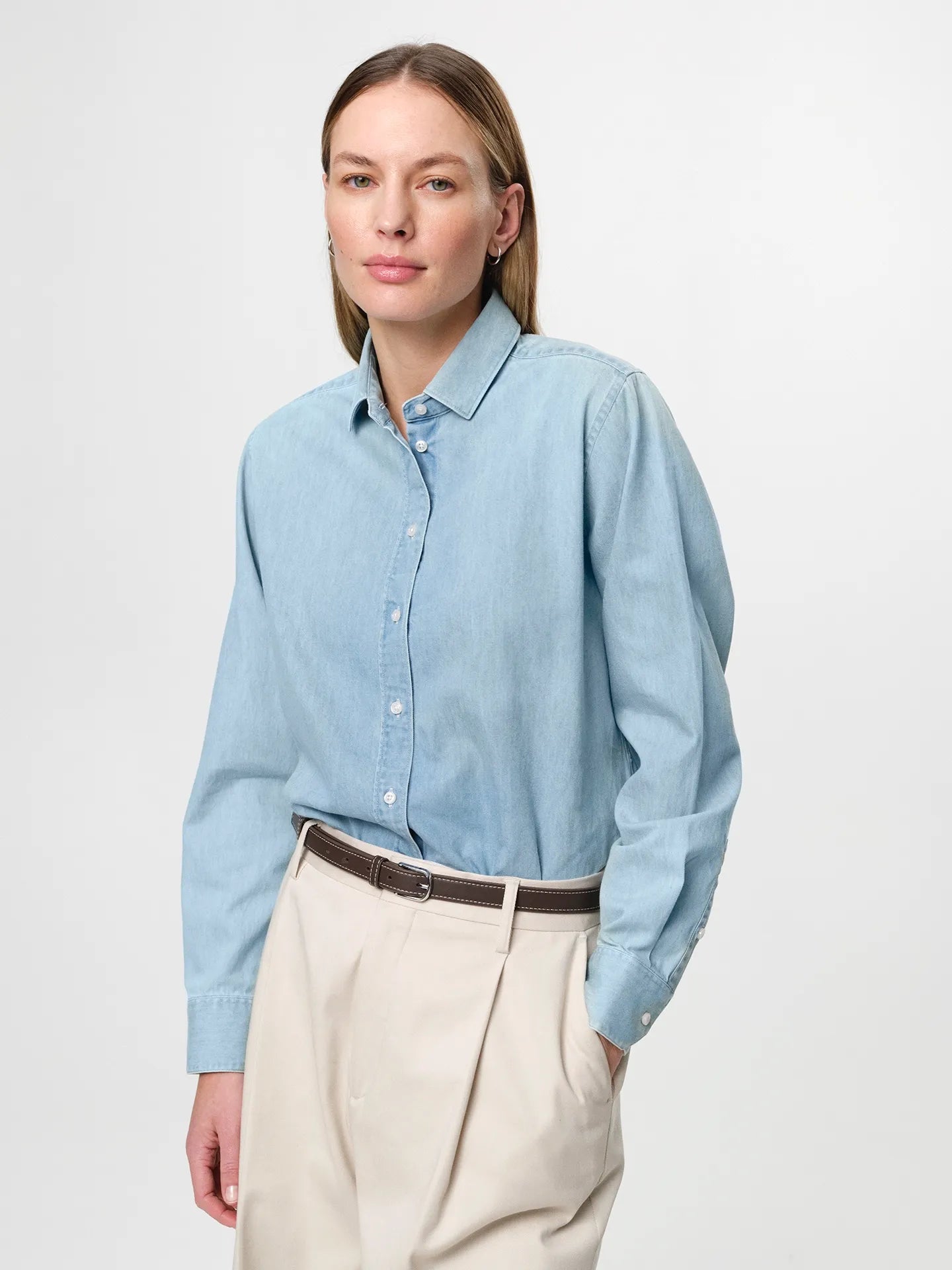 Julie Josephine Liv Light Denim Shirt: classic light denim shirt made from 100% cotton denim, designed with a fitted shoulder and a clean straight fit for an easy structured silhouette, styled for an elevated everyday look when paired with tailored trousers and a belt or worn casually over a tee.