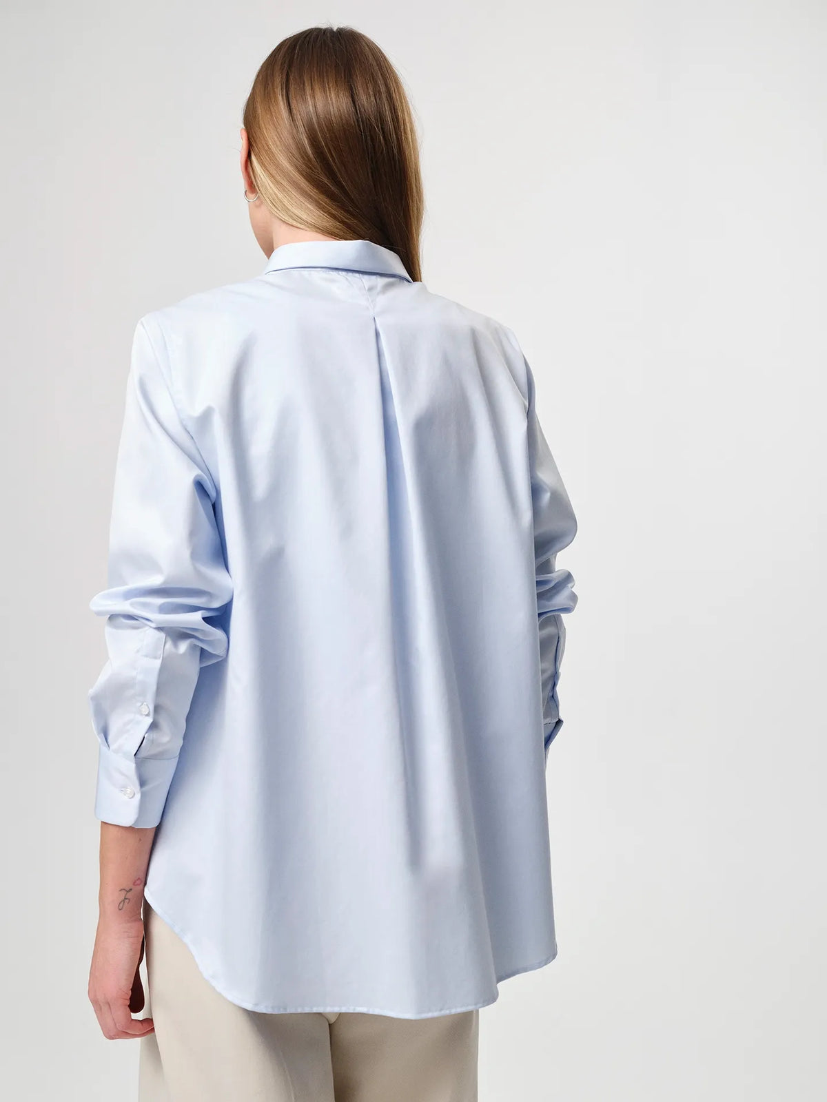 Sofie Shirt in light blue, made from crisp cotton twill with a soft A-line silhouette and curved hem for a relaxed look.