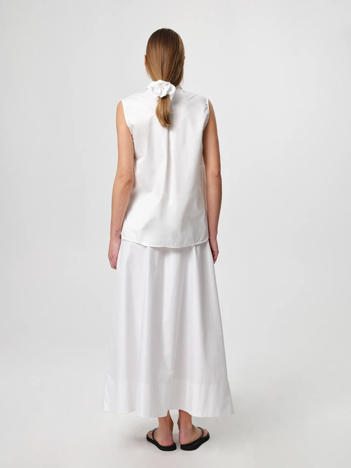 Sol Shirt in white, crafted from crisp cotton twill with an oversized fit, classic collar and gently curved hem.
