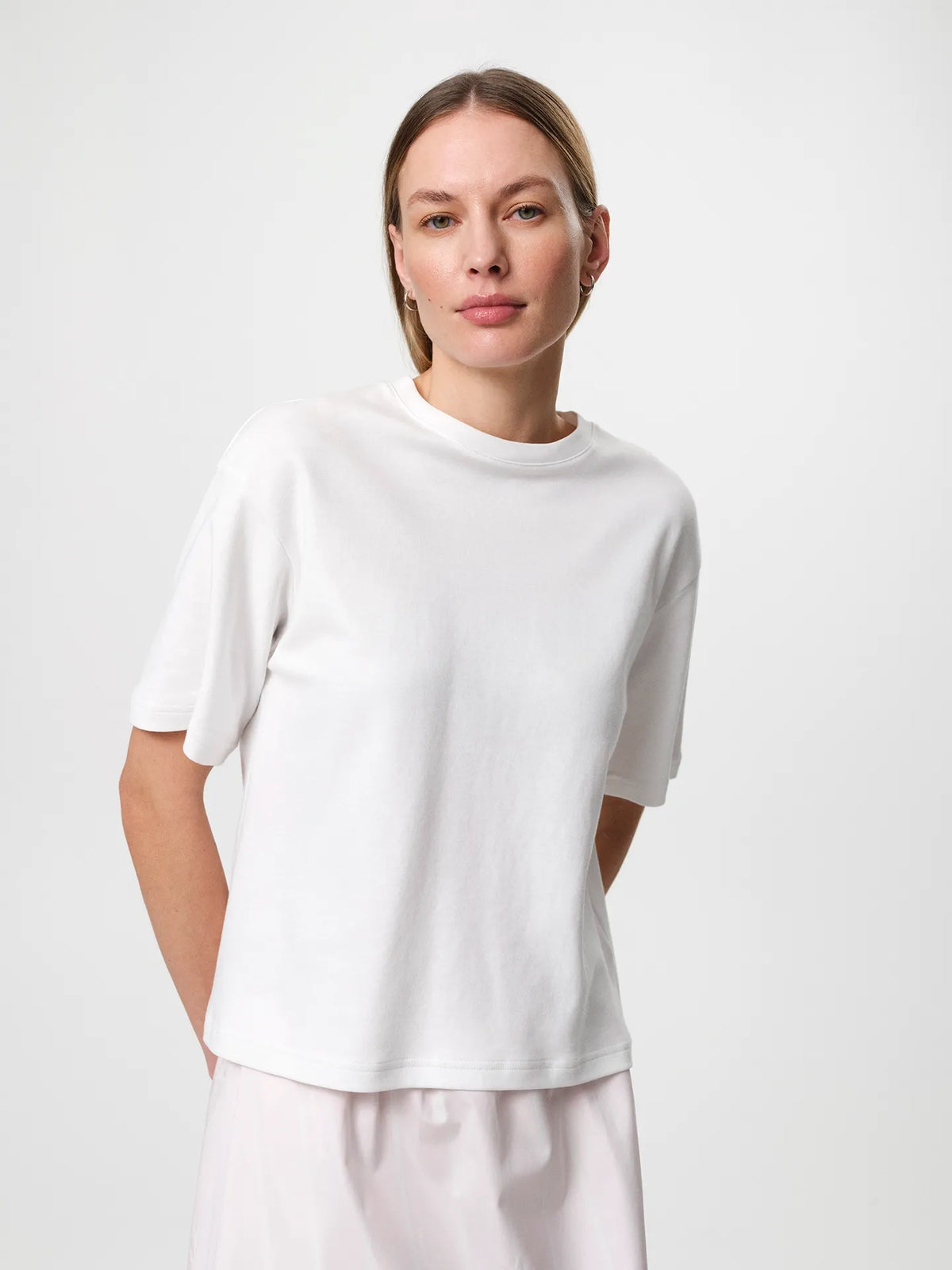 Stella T-shirt in white, crafted from soft organic cotton jersey with a classic crew neckline and relaxed fit.