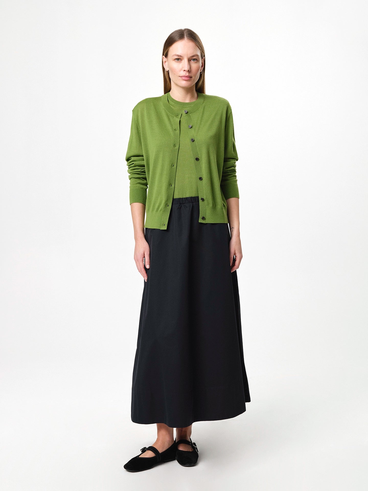 Julie Josephine Tanja Wool Top Tulip Green: refined sleeveless knit top made from 100% merino wool with a soft lightweight feel against the skin, clean regular fit with a classic crew neckline, designed for effortless layering worn on its own or under knits, blazers, and jackets, also styled over a shirt for a polished look, true to size with a relaxed silhouette and shown on a 173 cm model wearing size S.