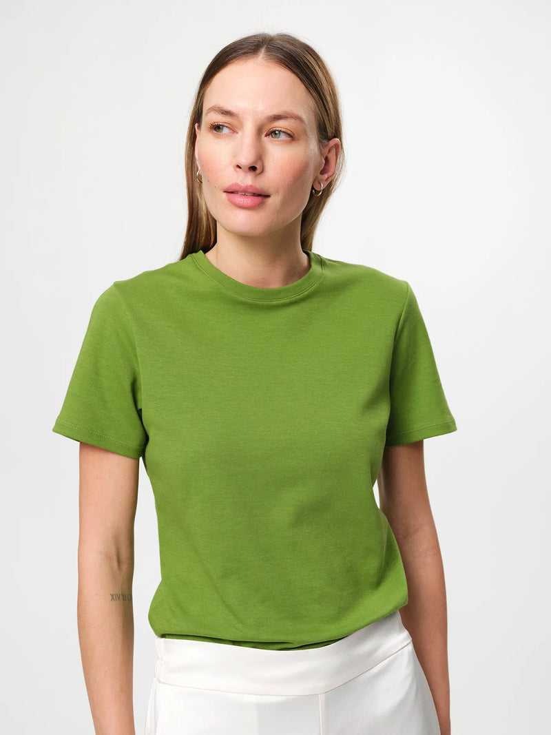 Julie Josephine Agnes Tee Tulip Green: relaxed fitted t shirt in tulip green made from soft Italian cotton jersey, designed as the perfect everyday tee and a seasonless wardrobe essential, effortless and versatile with a clean minimal silhouette, crafted for comfort and durability so it can be worn and washed endlessly.
