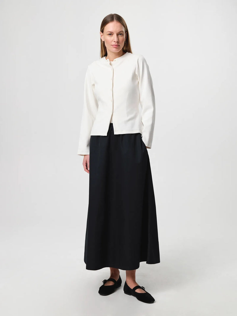 Julie Josephine Alba Top White Carla Cardigan: heavy rib cotton top in white with a clean minimal silhouette, designed as an everyday essential in a structured ribbed jersey that holds its shape, easy to style on its own or layered under shirts, blazers, and knitwear.
