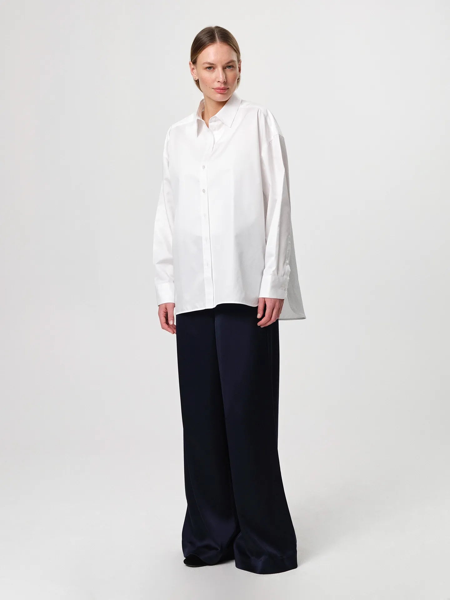 Edwina Shirt in white, cut from crisp cotton poplin with an oversized tailored silhouette, sharp collar, dropped shoulders and a gently curved hem.