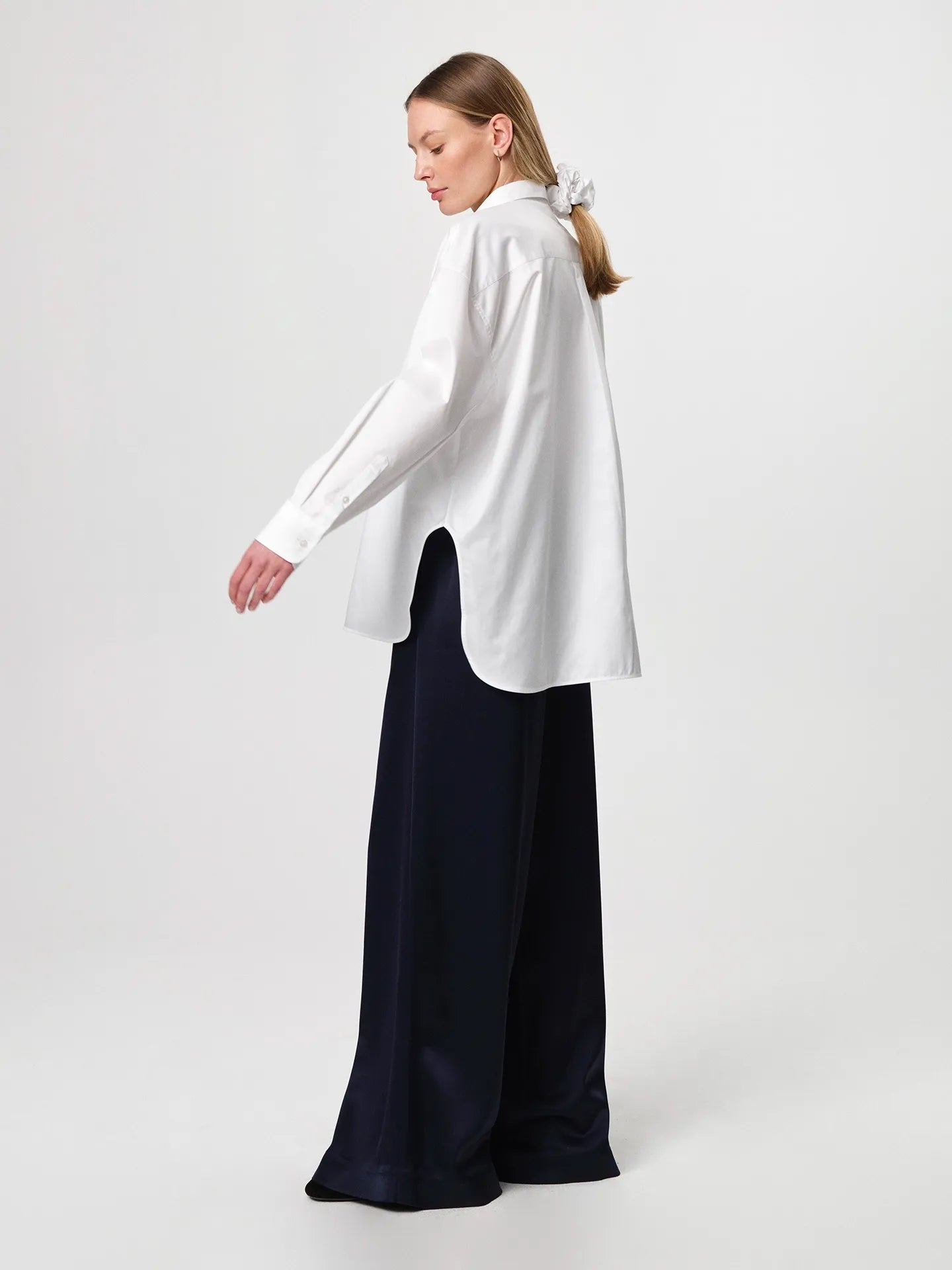Edwina Shirt in white, cut from crisp cotton poplin with an oversized tailored silhouette, sharp collar, dropped shoulders and a gently curved hem.