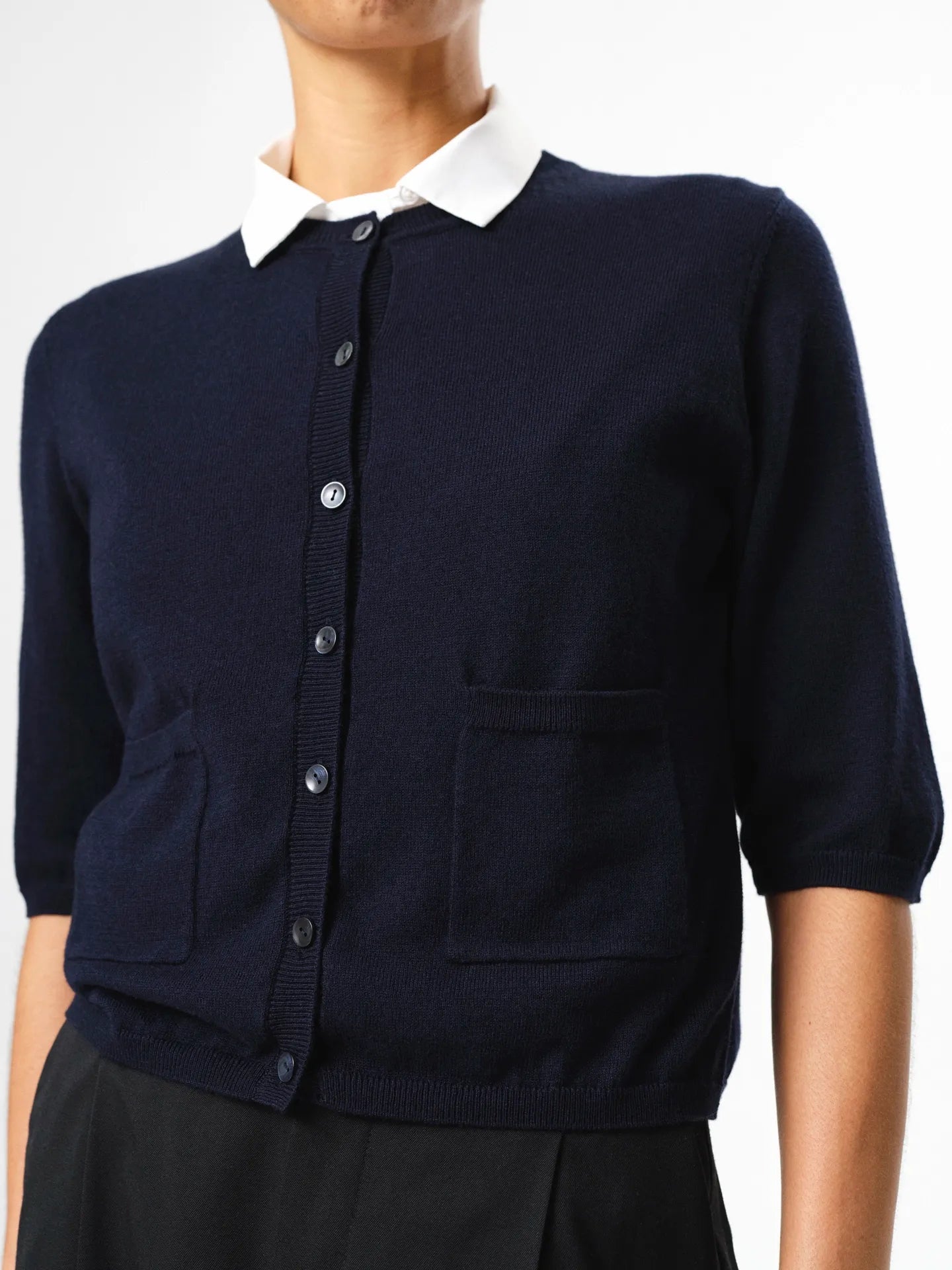 Evelyn Cardigan in dark navy, crafted from a soft wool–cotton blend with button-front closure, half sleeves and discreet front pockets.