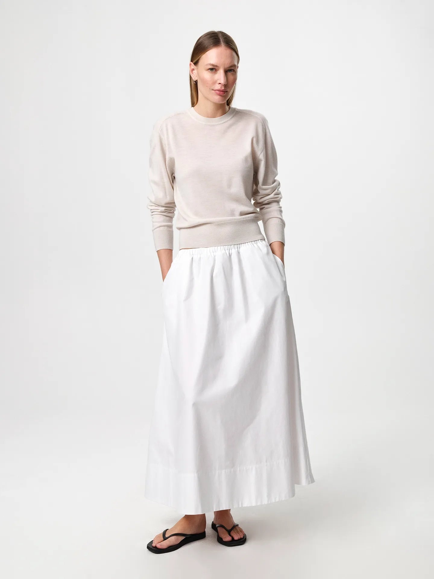 Julie Josephine Hanne Sweater Oatmeal: modern wardrobe essential knit sweater in an oatmeal shade, crafted from 100% fine merino wool with a lightweight knit that gives soft warmth and a luxurious feel against the skin, designed with a classic round neckline and a clean timeless silhouette that works worn on its own or layered over a t shirt for an effortless everyday look.