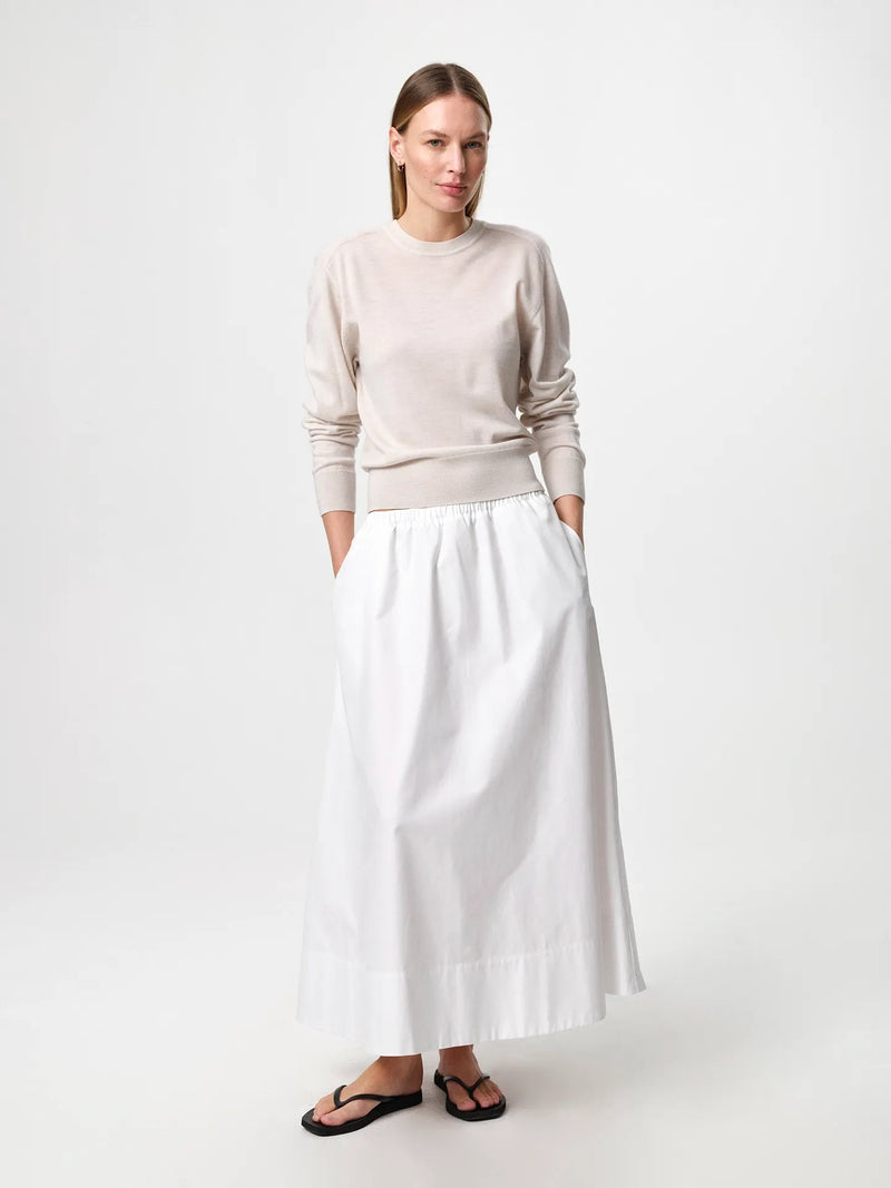 Julie Josephine Hanne Sweater Oatmeal: modern wardrobe essential knit sweater in an oatmeal shade, crafted from 100% fine merino wool with a lightweight knit that gives soft warmth and a luxurious feel against the skin, designed with a classic round neckline and a clean timeless silhouette that works worn on its own or layered over a t shirt for an effortless everyday look.