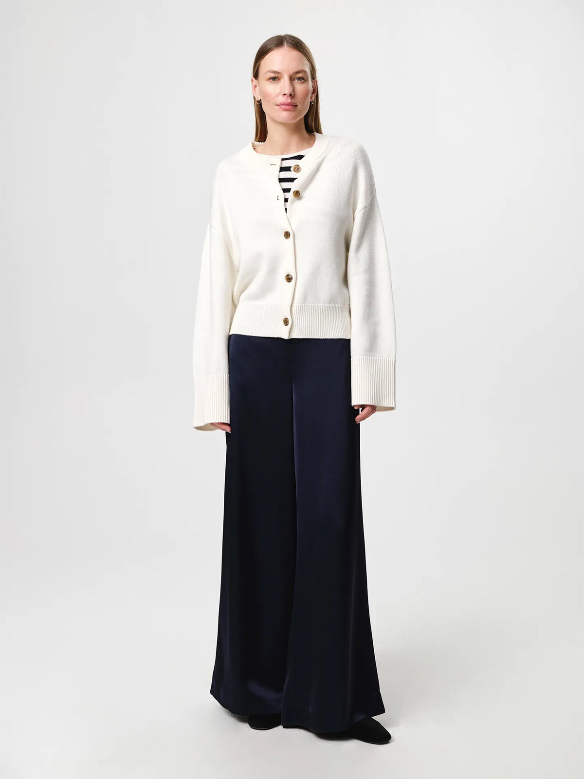 Julie Josephine Henrikke Cardigan: timeless knit cardigan in a 50% wool and 50% cotton blend, designed with a relaxed silhouette and wide loose sleeves, a more fitted waist, ribbed neckline, classic front button fastening, extended loose ribbed cuffs, and a ribbed hem for an understated everyday layering piece.
