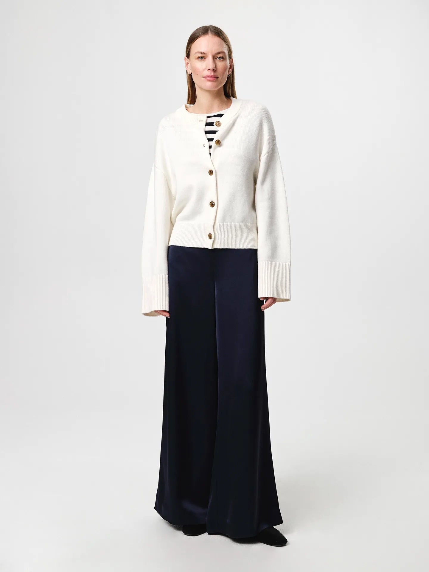 Julie Josephine Henrikke Cardigan: timeless knit cardigan in a 50% wool and 50% cotton blend, designed with a relaxed silhouette and wide loose sleeves, a more fitted waist, ribbed neckline, classic front button fastening, extended loose ribbed cuffs, and a ribbed hem for an understated everyday layering piece.