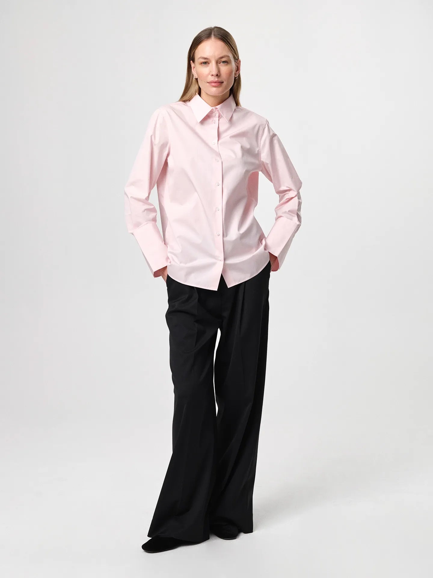 Julie Josephine Julie Shirt Peony Pink: iconic bestselling cotton twill shirt in peony pink made from crisp 100% cotton, tailored with a fitted shoulder and clean straight body for a polished silhouette, finished with elongated statement cuffs and a modern curved hem, designed to wear untucked or layered under a favorite knit with the cuffs showing, crafted in Portugal as a timeless wardrobe staple made to be worn, loved, and kept for years.