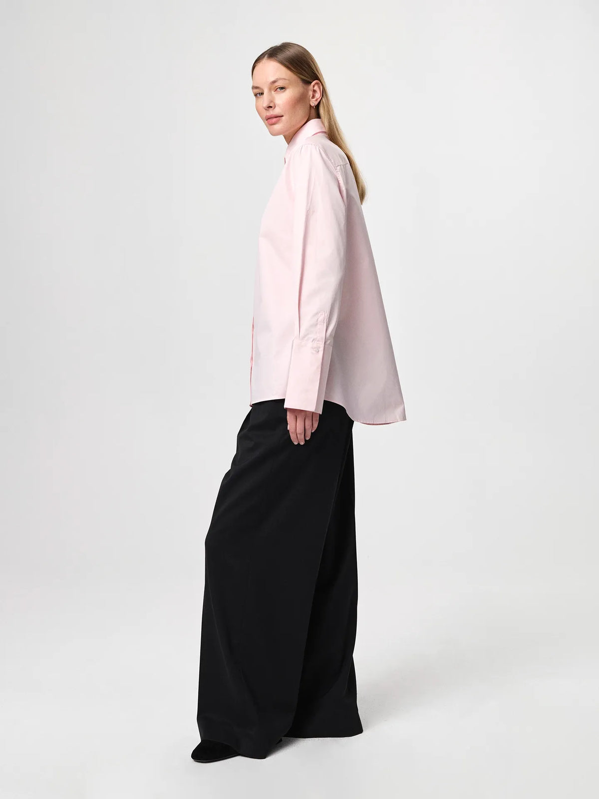 Julie Josephine Julie Shirt Peony Pink: iconic bestselling cotton twill shirt in peony pink made from crisp 100% cotton, tailored with a fitted shoulder and clean straight body for a polished silhouette, finished with elongated statement cuffs and a modern curved hem, designed to wear untucked or layered under a favorite knit with the cuffs showing, crafted in Portugal as a timeless wardrobe staple made to be worn, loved, and kept for years.
