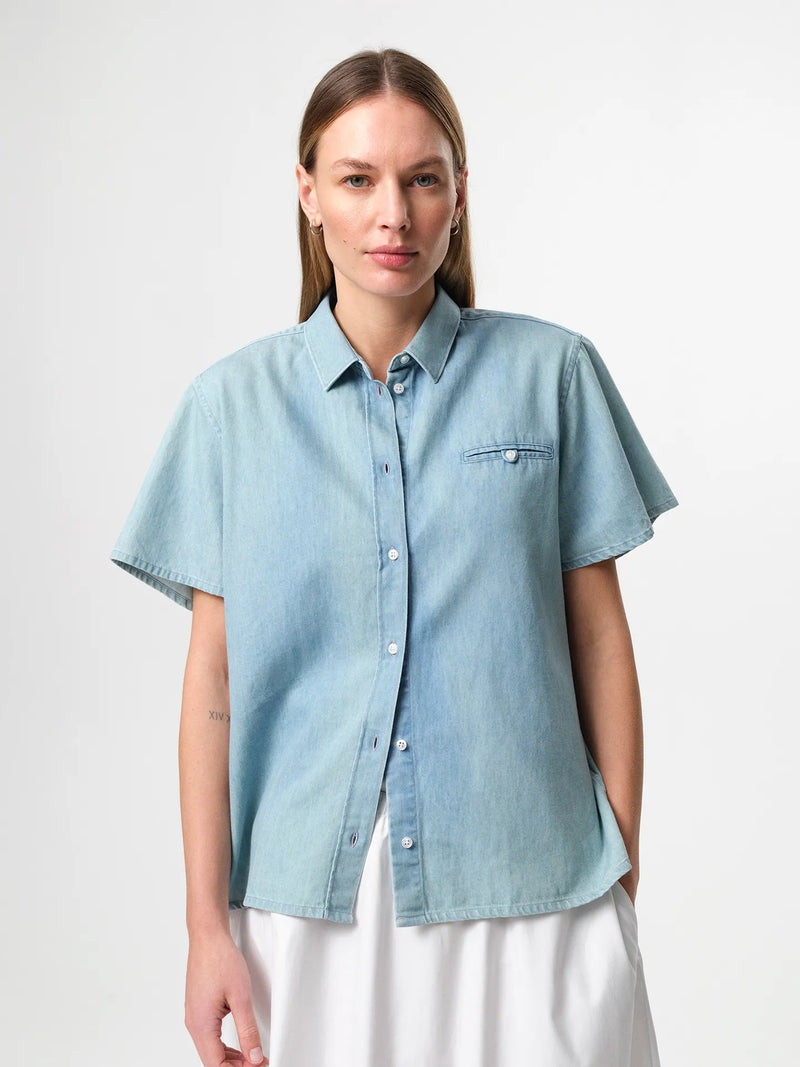 Julie Josephine June Denim Shirt Light Denim: light denim shirt in a pale blue wash designed with a clean classic silhouette for effortless everyday styling, a versatile wardrobe staple to wear buttoned up on its own or layered open over a tee, easy to dress up with tailored pieces or keep casual with denim.