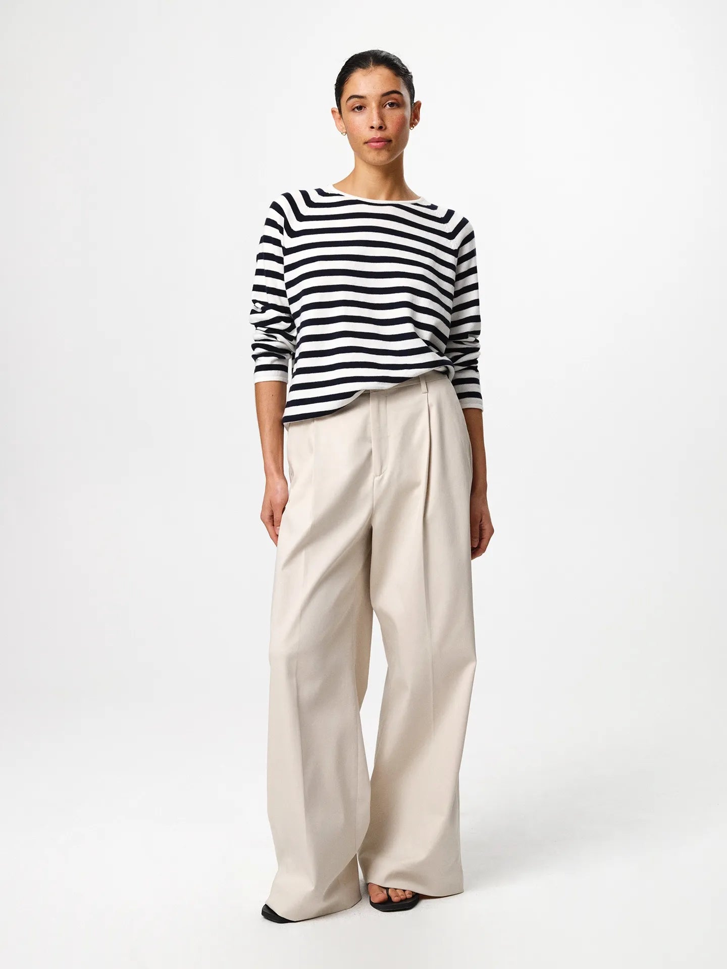 Julie Josephine Kate Roundneck Sweater Navy Stripe: product photo of a refined everyday knit in a navy and off white stripe pattern, made from a soft wool and cotton blend that balances natural warmth with breathable lightness, featuring a relaxed silhouette with subtle dropped shoulders and a clean V neckline, styled for effortless layering over a T shirt or worn on its own with tailored trousers or denim.