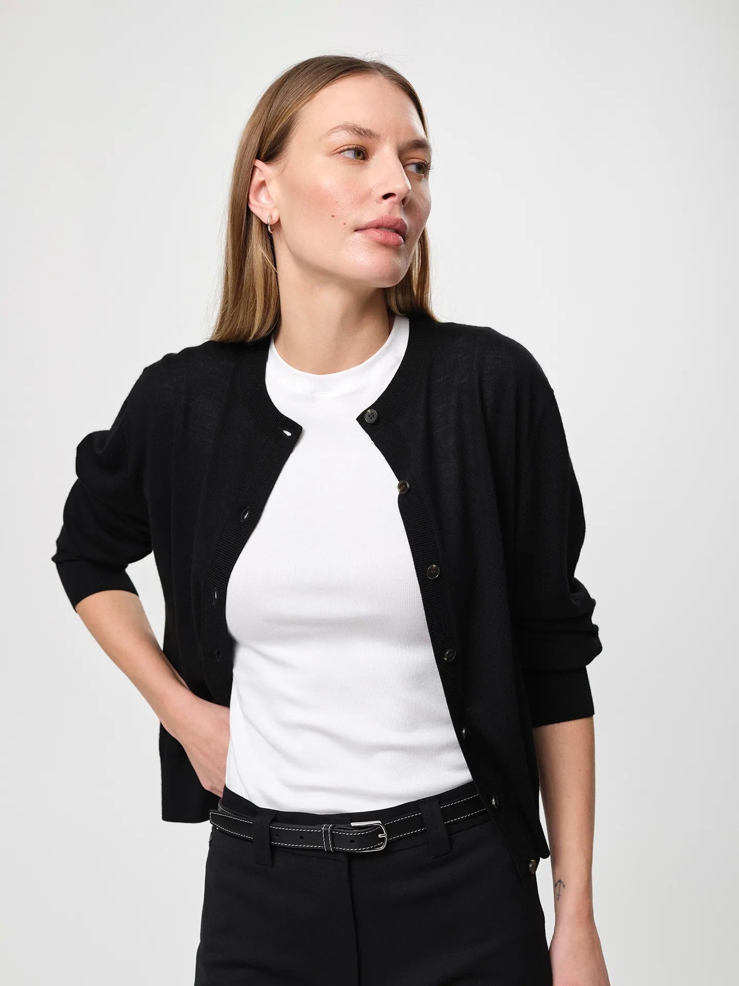 Lilja Merino Cardigan in black, crafted from 100% fine merino wool with a regular fit, round neckline, ribbed hem and lightweight knit quality designed for layering.