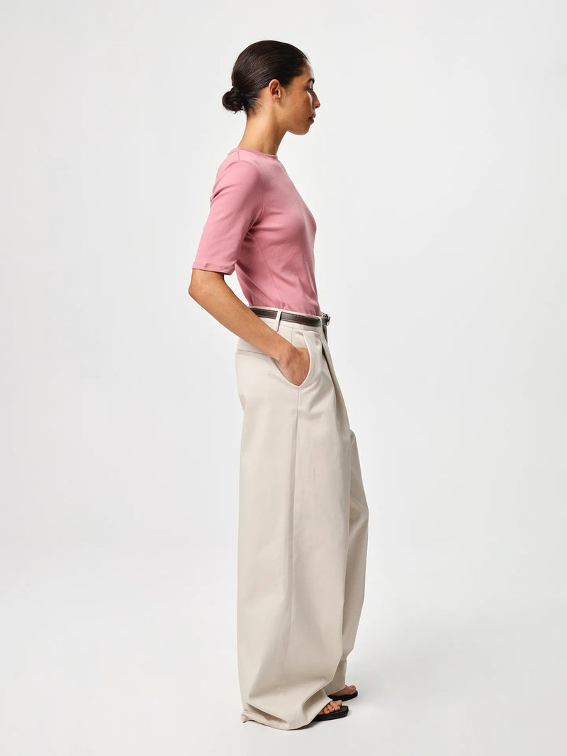 Julie Josephine Marianne Rib Tee Rosy Pink: capsule wardrobe rib tee in rosy pink made from 94% Italian pima cotton and 6% polyamide, crafted in soft structured Italian cotton rib jersey with a slim flattering fit, classic round neckline and elbow length sleeves that balance comfort and shape, designed for effortless versatility worn on its own or layered under shirts, knits, and blazers.