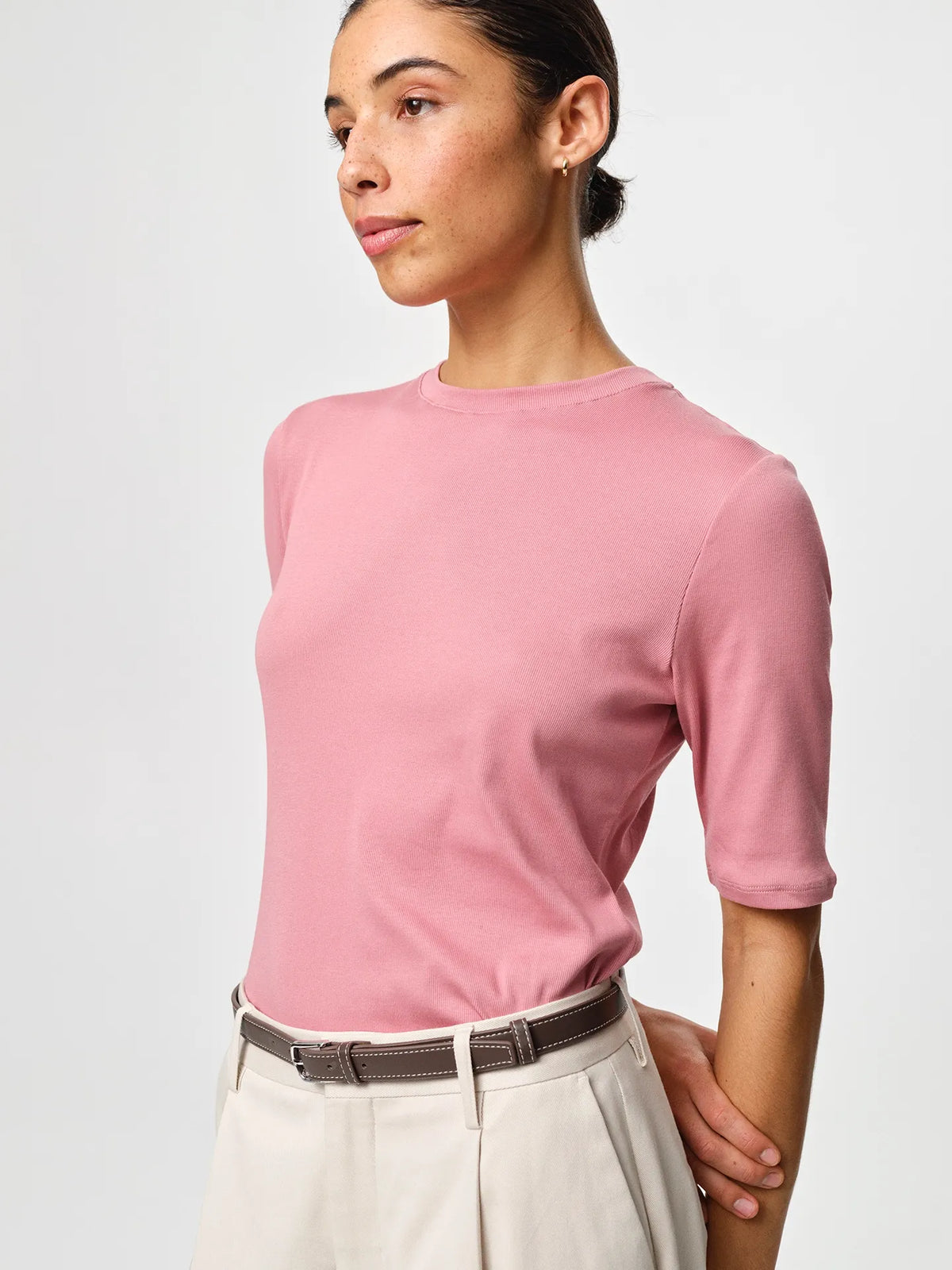 Julie Josephine Marianne Rib Tee Rosy Pink: capsule wardrobe rib tee in rosy pink made from 94% Italian pima cotton and 6% polyamide, crafted in soft structured Italian cotton rib jersey with a slim flattering fit, classic round neckline and elbow length sleeves that balance comfort and shape, designed for effortless versatility worn on its own or layered under shirts, knits, and blazers.