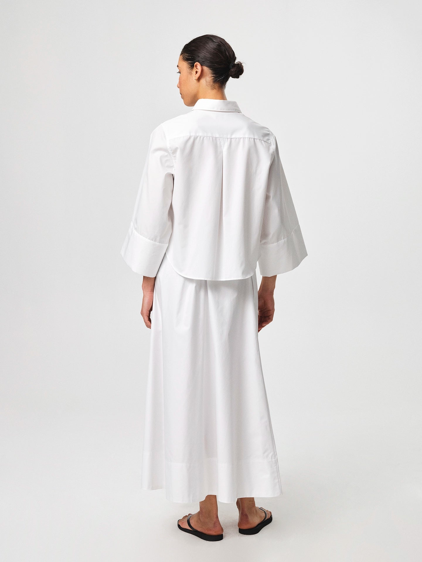 Julie Josephine Anja Shirt White: crisp white shirt made from 100% cotton with a clean classic silhouette, designed as a versatile wardrobe staple that works polished on its own or layered under knitwear and outerwear for effortless everyday styling.