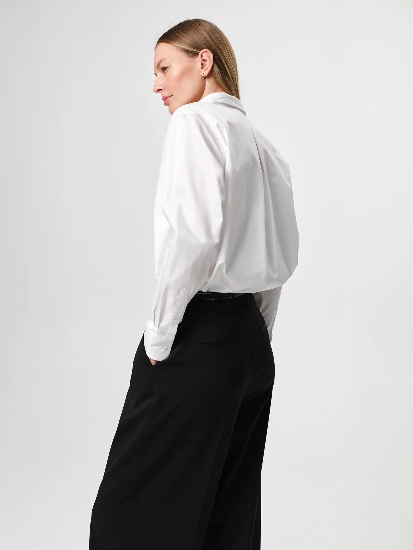 Sofie Shirt in white, made from crisp cotton twill with a soft A-line silhouette and curved hem for a relaxed look.