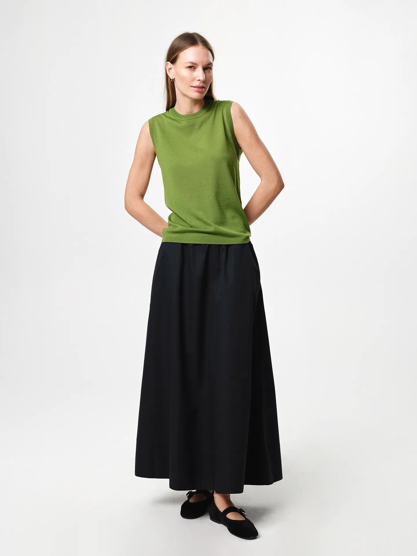 Julie Josephine Tanja Wool Top Tulip Green: product photo of a refined sleeveless knit top in tulip green, made from 100% merino wool with a soft lightweight feel, featuring a clean regular fit and classic crew neckline, designed as a versatile layering piece worn on its own or under knits, blazers, and jackets for year round wear.