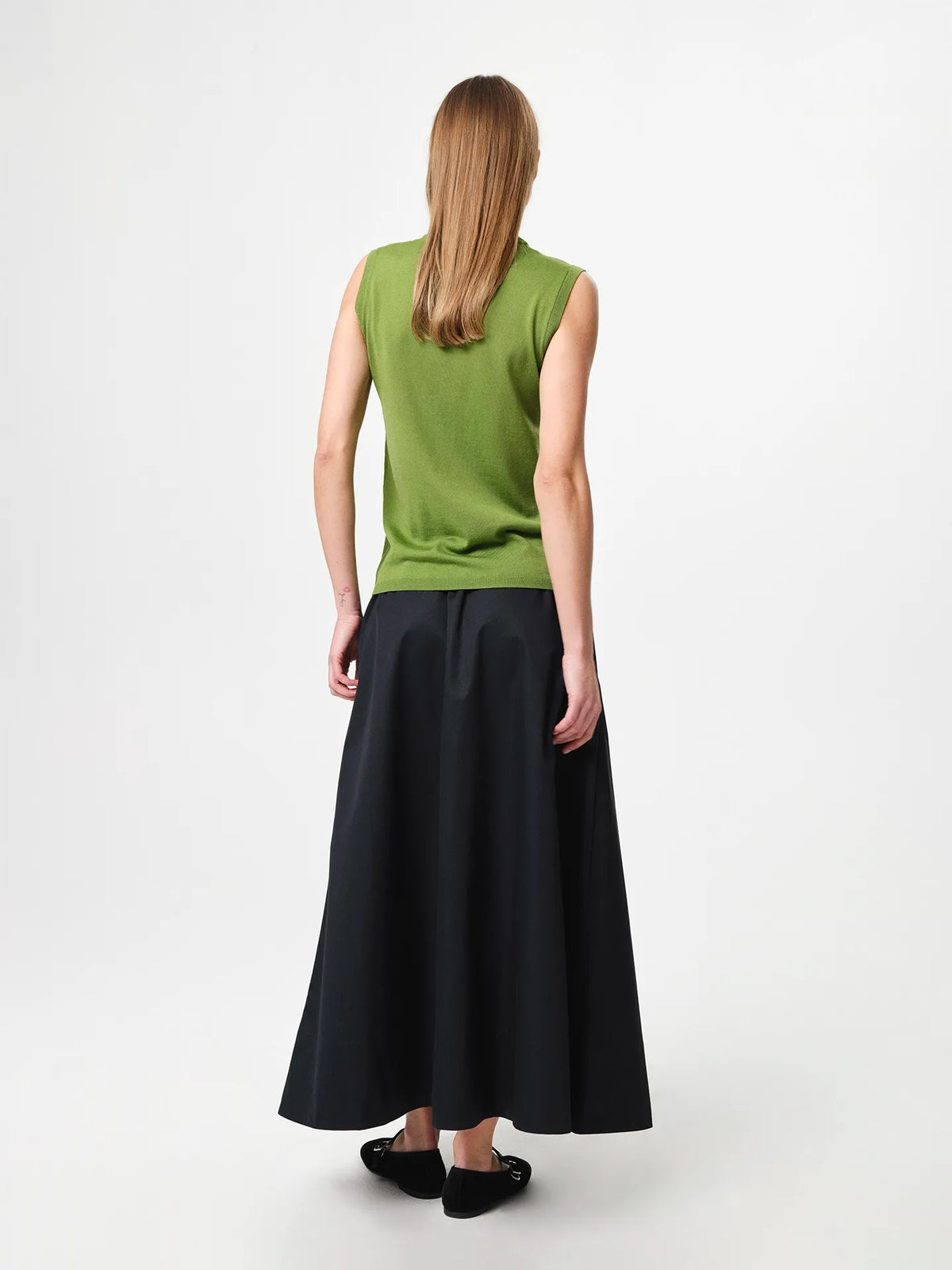 Julie Josephine Tanja Wool Top Tulip Green: product photo of a refined sleeveless knit top in tulip green, made from 100% merino wool with a soft lightweight feel, featuring a clean regular fit and classic crew neckline, designed as a versatile layering piece worn on its own or under knits, blazers, and jackets for year round wear.